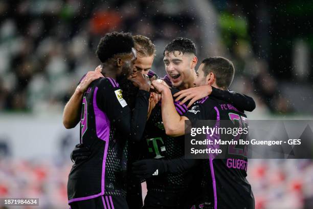 Jamal Musiala of Munich celebrates Alphonso Davies, Harry Kane, Aleksandar Pavlovic and Raphael Guerreiro after scoring his team's first goal during...