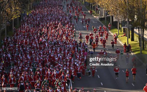 People dressed as Santa Claus take part in the annual Santa Claus run which starts and ends at Plaza de Colon in Madrid, Spain on December 24, 2023.