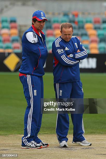 England captain Alastair Cook and England coach Andy Flower inspect the pitch before play is abandoned for the day during day two of the tour match...