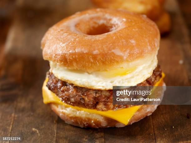 glazed donut breakfast sandwich - sausage patty stock pictures, royalty-free photos & images