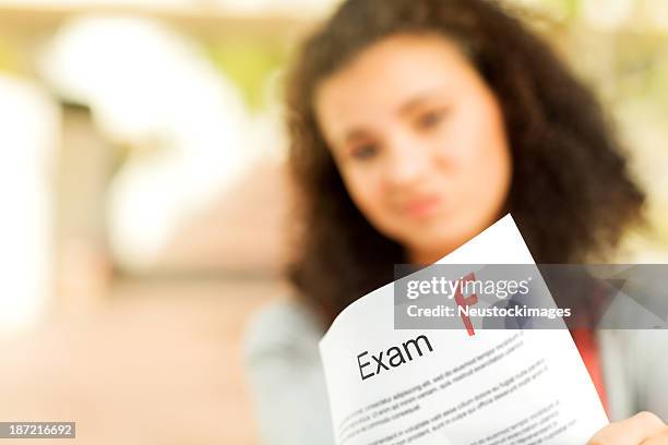 student showing exam result with f grade on campus - f 16 stock pictures, royalty-free photos & images