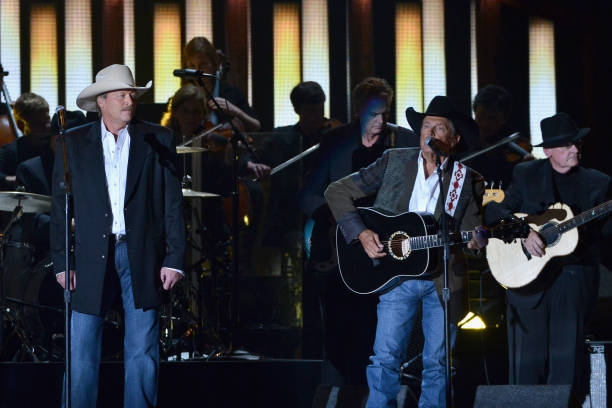 Alan Jackson and Entertainer of the Year award winner George Strait perform onstage during the 47th annual CMA awards at the Bridgestone Arena on...
