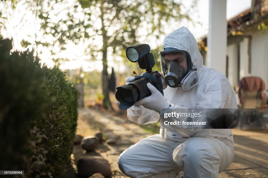 Forensic scientist photographing evidence