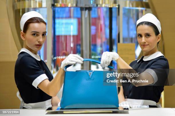 Models pose during a photocall to launch the Louis Vuitton Townhouse at Selfridges on November 7, 2013 in London, England. The first Louis Vuitton...