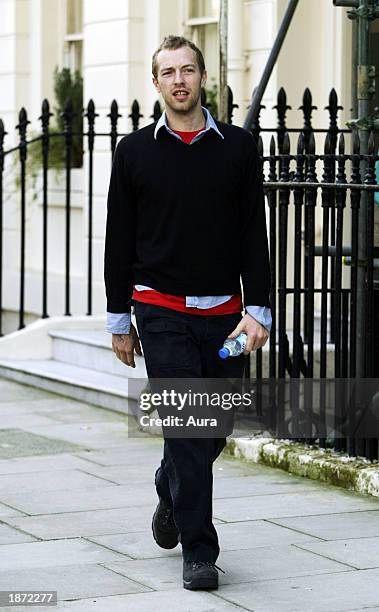 Singer Chris Martin of British band "Coldplay" leaves his house in Knightsbridge as he makes his way to a recording studio March 26, 2003 in London....