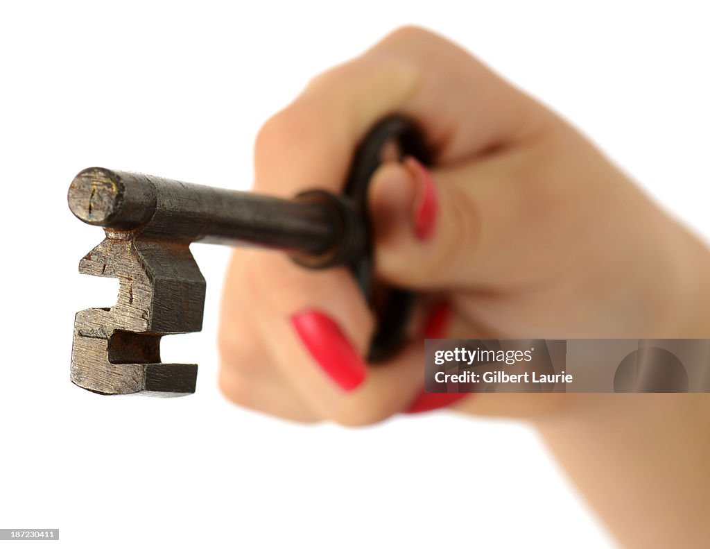 Woman's hand holding an antique key