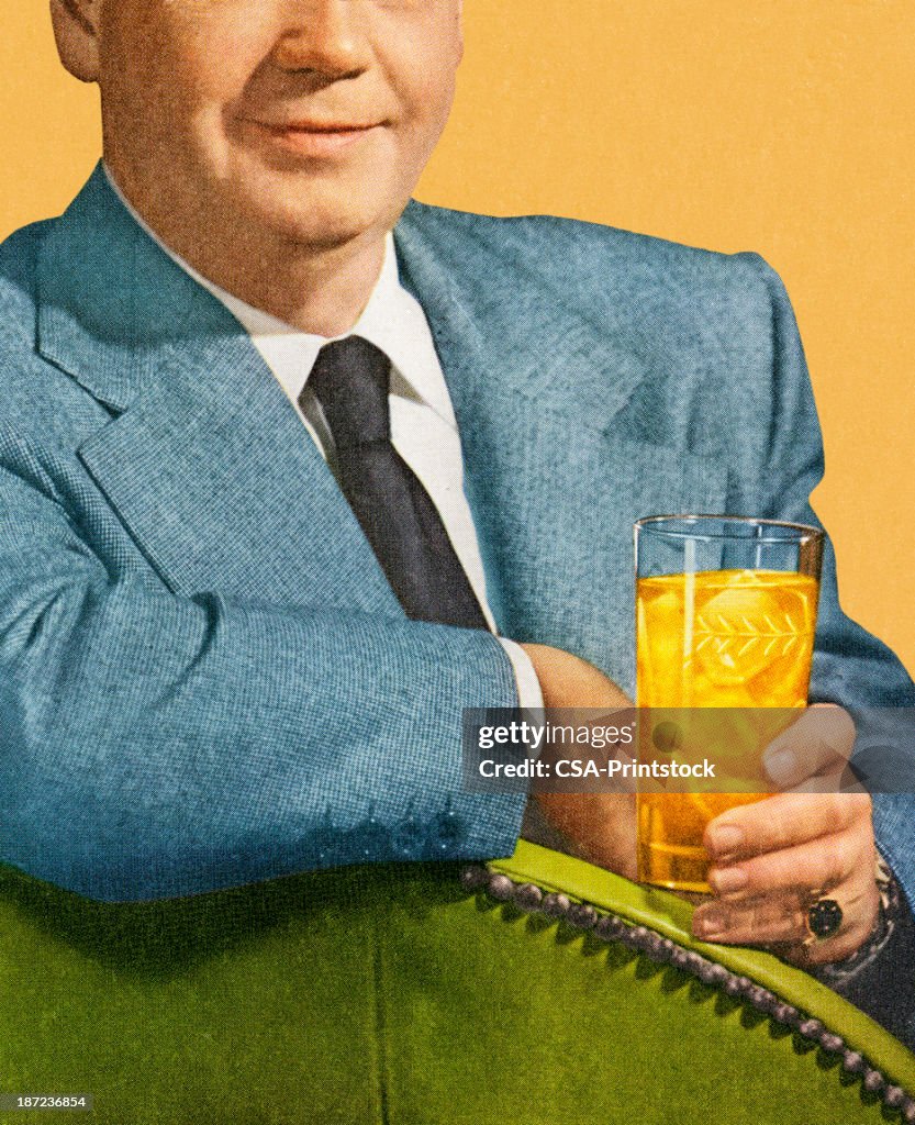 Man Sitting and Holding Drink