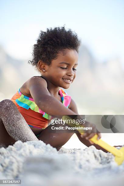 building sandcastles - black girl swimsuit stock pictures, royalty-free photos & images