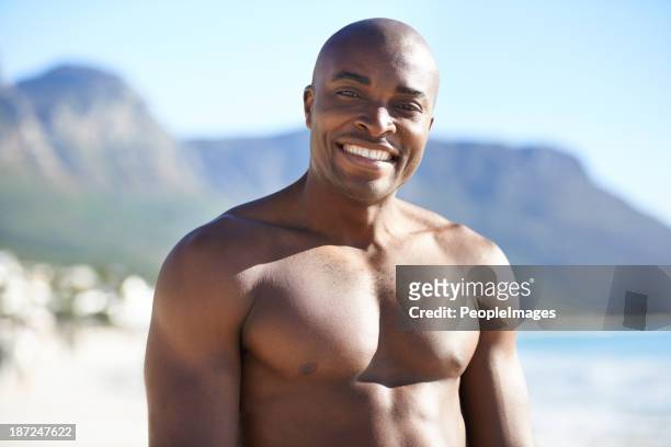 enjoying the summer sun - hunky guy on beach stock pictures, royalty-free photos & images
