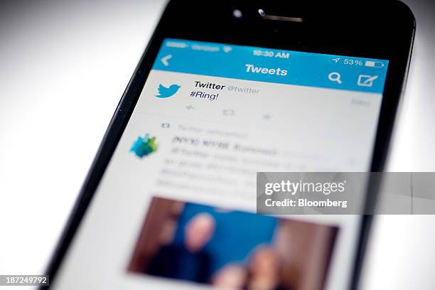 Twitter Inc. Tweet regarding the company ringing the opening bell on the New York Stock Exchange is displayed on an Apple Inc. IPhone arranged for a...