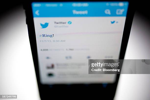 Twitter Inc. Tweet regarding the company ringing the opening bell on the New York Stock Exchange is displayed on an Apple Inc. IPhone arranged for a...