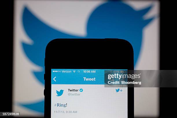 Twitter Inc. Tweet regarding the company ringing the opening bell on the New York Stock Exchange is displayed on an Apple Inc. IPhone arranged for a...