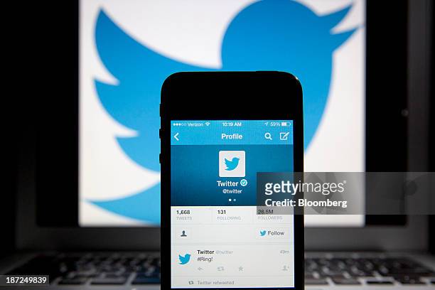 Twitter Inc. Tweet regarding the company ringing the opening bell on the New York Stock Exchange is displayed on an Apple Inc. IPhone arranged for a...