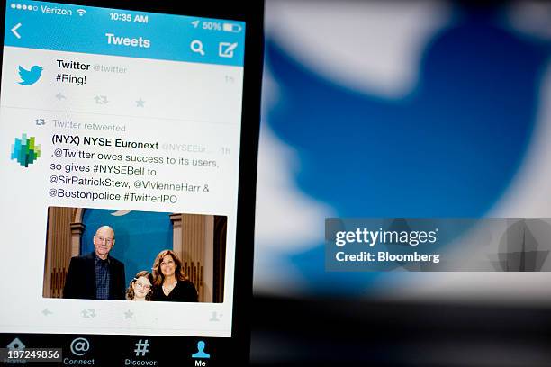 Twitter Inc. Tweet regarding the company ringing the opening bell on the New York Stock Exchange is displayed on an Apple Inc. IPhone arranged for a...