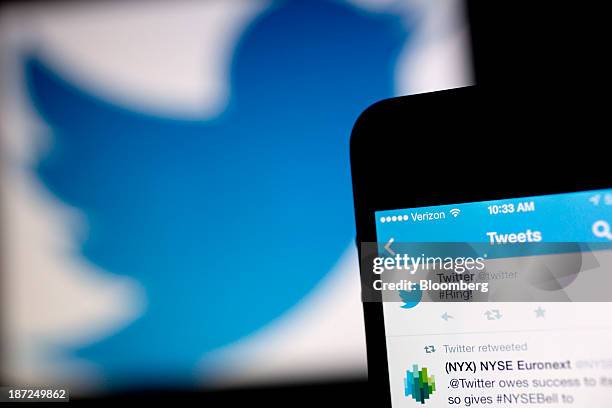 Twitter Inc. Tweet regarding the company ringing the opening bell on the New York Stock Exchange is displayed on an Apple Inc. IPhone arranged for a...