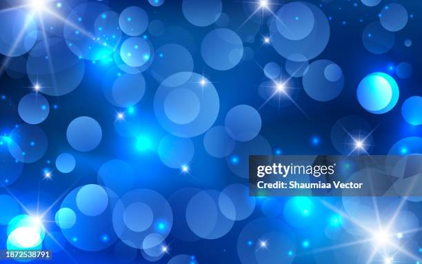 abstract blue christmas bokeh lights and shiny sparkling background design - magic sparkle stock illustrations