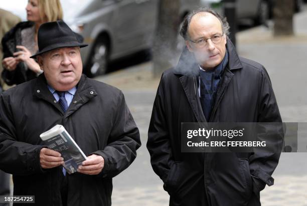 French journalists Gerard Carreyrou and Yves Threard arrive at the Saint Honore d'Eylau church in Paris to attend the funeral ceremony of French...