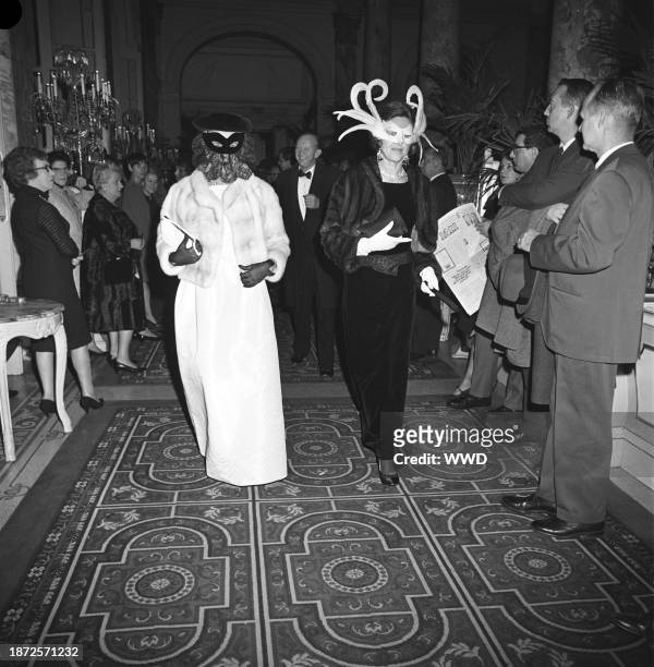 Two women in masks arriving at Truman Capote's Black and White Ball in the Grand Ballroom at the Plaza Hotel in New York City