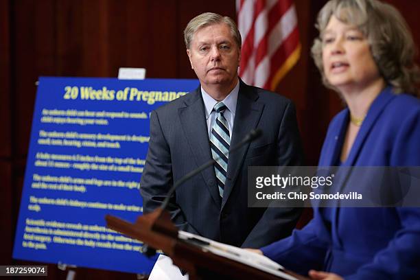 Sen. Lindsey Graham listens to National Right to Life Committee President Carol Tobias speak during a news conference to introduce new legislation,...