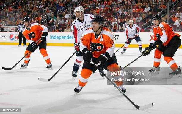 Kimmo Timonen, Luke Schenn and Adam Hall of the Philadelphia Flyers defend against Troy Brouwer of the Washington Capitals on November 1, 2013 at the...