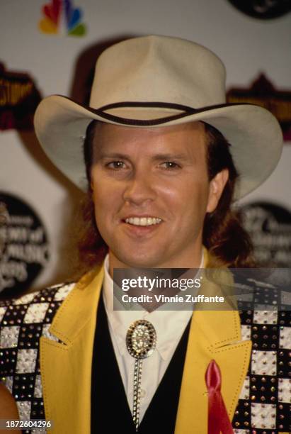 American singer and musician Mark Miller, wearing a yellow jacket with checkerboard embellishment and a cowboy hat, in the press room of the 27th...