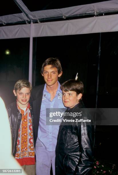 American actor Lukas Haas wearing a pinstripe jacket over a blue embroidered shirt, and his brothers, twins Nikki Haas and Simon Haas, attend a...