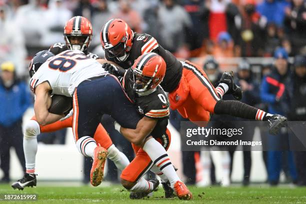 Cole Kmet of the Chicago Bears is tackled by Greg Newsome II and Jeremiah Owusu-Koramoah of the Cleveland Browns during the first half at Cleveland...