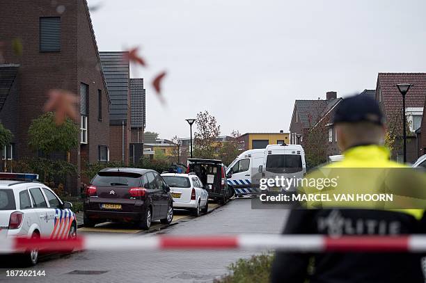 Police officer stands in the cordoned off area around a house in Reuver on November 7 where a Dutch man killed his three-year-old daughter before...
