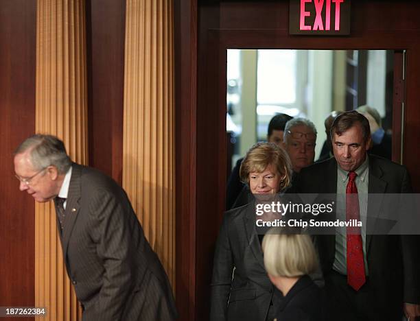 Senate Majority Leader Harry Reid , Sen. Tammy Baldwin and Sen. Jeff Merkley and other Democrats arrive for a news conference before the final...