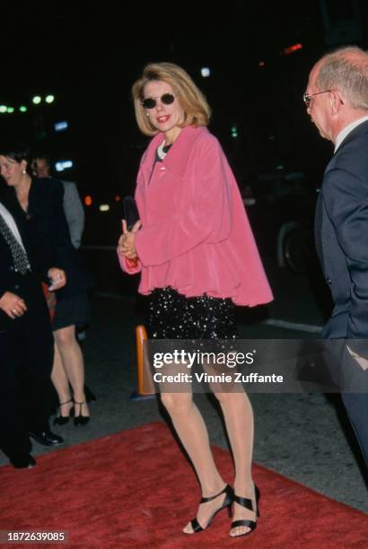 American actress and singer Christine Baranski, wearing a pink jacket over a black dress, with a multi-strand pearl necklace, attends the Westwood...