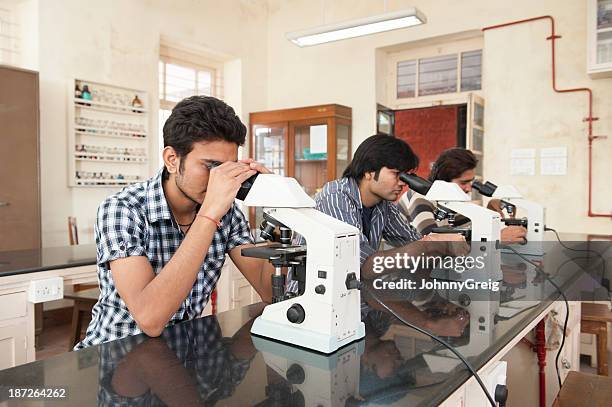 indian science students using microscopes - india lab stockfoto's en -beelden