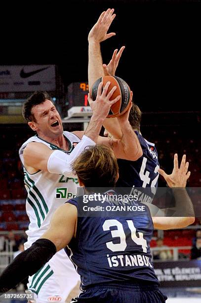 Zalgiris Kaunas` Ksistof Lavrinovic vies for the ball with Anadolu Efes` Zoran Planinic and Stanko Barac during their Euroleague group B basketball...