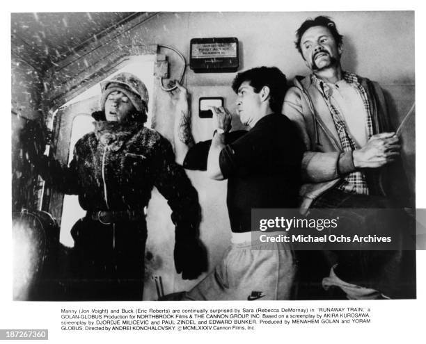 Actress Rebecca De Mornay, actors Eric Roberts and Jon Voight on the set of the Cannon Films movie "Runaway Train" in 1985.