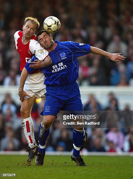 Dennis Bergkamp of Arsenal wins the header against David Unsworth of Everton during the FA Barclaycard Premiership match held on March 23, 2003 at...
