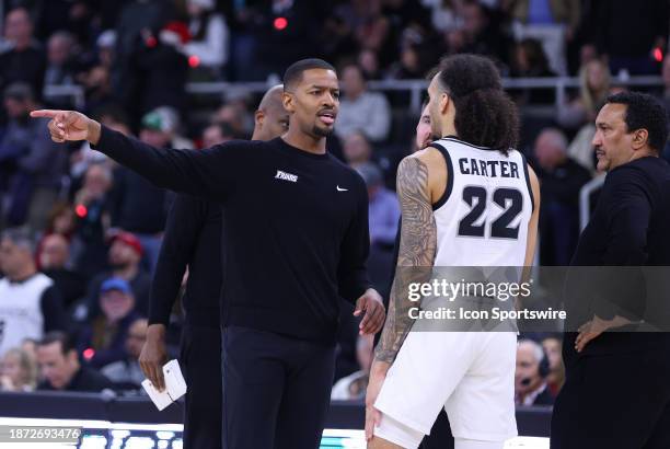 Providence Friars head coach Kim English instructs Providence Friars guard Devin Carter during a timeout during the college basketball game between...