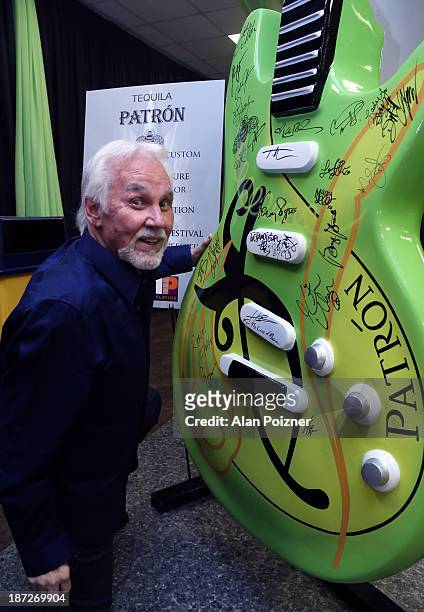 Kenny Rogers signs a giant Patron tequila guitar backstage at the CMA Awards to benefit the "Keep the Music Playing" music education on November 3,...