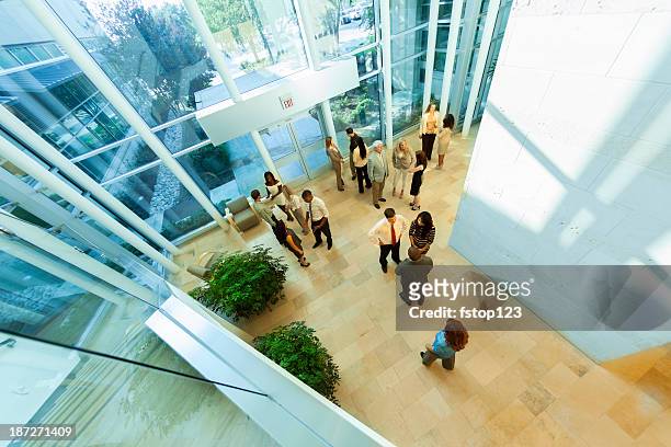 business: group of multi-ethnic, co-workers arrive for work. - headquarters stock pictures, royalty-free photos & images