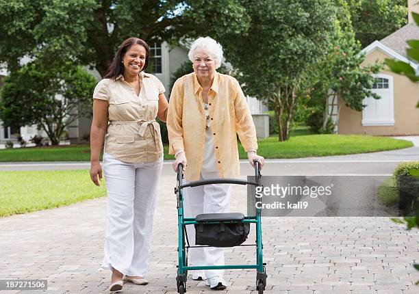 senior woman with caregiver - walking frame stock pictures, royalty-free photos & images