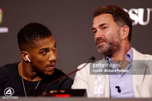 Anthony Joshua speaks with Promotor Eddie Hearn, Chairman of Matchroom Sport, during the press conference ahead of the Heavyweight fight between...