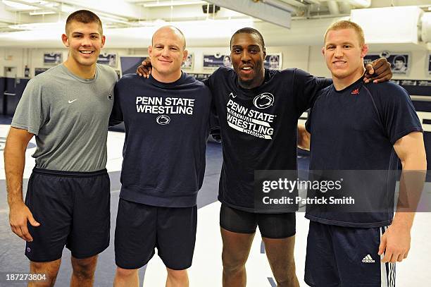 Light heavyweight fighter Phil Davis poses with Penn State coach Quentin Wright , head coach Cael Sanderson and coach Jake Varner during the '20 days...