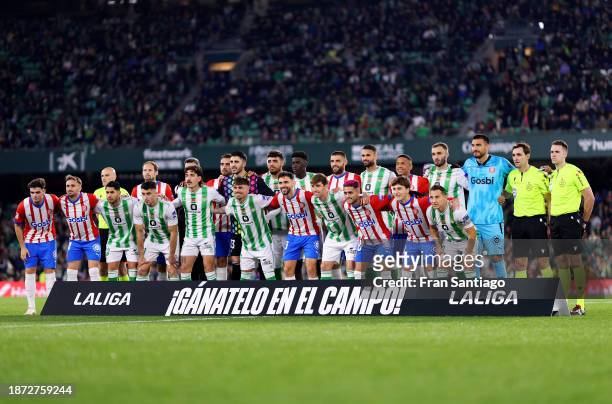Players and match officials pose for a photo prior to the LaLiga EA Sports match between Real Betis and Girona FC at Estadio Benito Villamarin on...