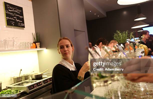 Waitress prepares salads as a guest takes one at the Digital Eatery at the opening of the Microsoft Center Berlin on November 7, 2013 in Berlin,...