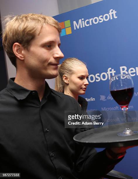 Waiter carries a glass of wine at the opening of the Microsoft Center Berlin on November 7, 2013 in Berlin, Germany. The Microsoft Center Berlin,...