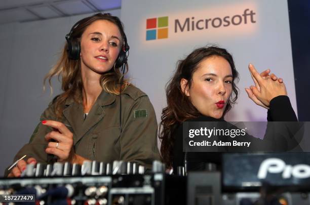 DJs dance while playing music at the opening of the Microsoft Center Berlin on November 7, 2013 in Berlin, Germany. The Microsoft Center Berlin, part...