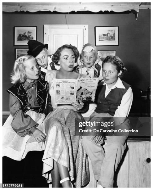 Publicity portrait of actor Joan Crawford alongside her daughter Christina Crawford singing an operetta sung by Engelbert Humperdinck of the classic...