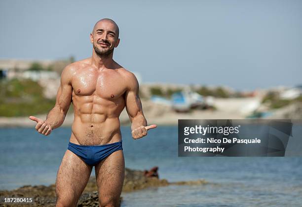 smiling man enjoying sun at sea - muscle men at beach stock pictures, royalty-free photos & images