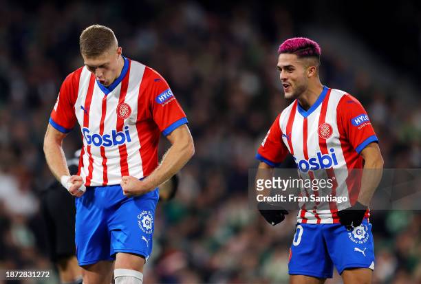 Artem Dovbyk of Girona FC celebrates with teammate Yan Couto after scoring their team's first goal from a penalty kick during the LaLiga EA Sports...