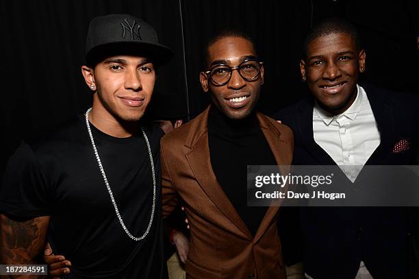 Formula One driver Lewis Hamilton, Tinie Tempah and Labrinth pose during the Beats by Dre present Tinie Tempah's album launch party at DSTRKT on...