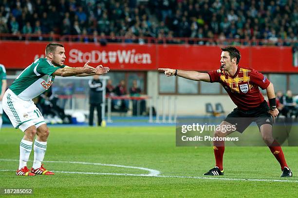 Referee Firat Aydinus points to the penalty spot during the UEFA Europa League group stage match between SK Rapid Wien and KRC Genk at the Ernst...