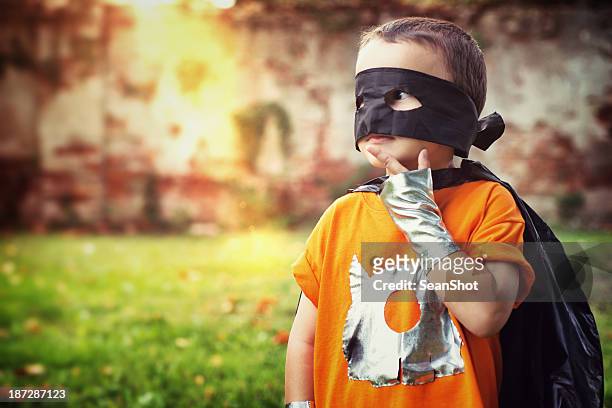 little superhero thinking the right solution - baby superhero stock pictures, royalty-free photos & images